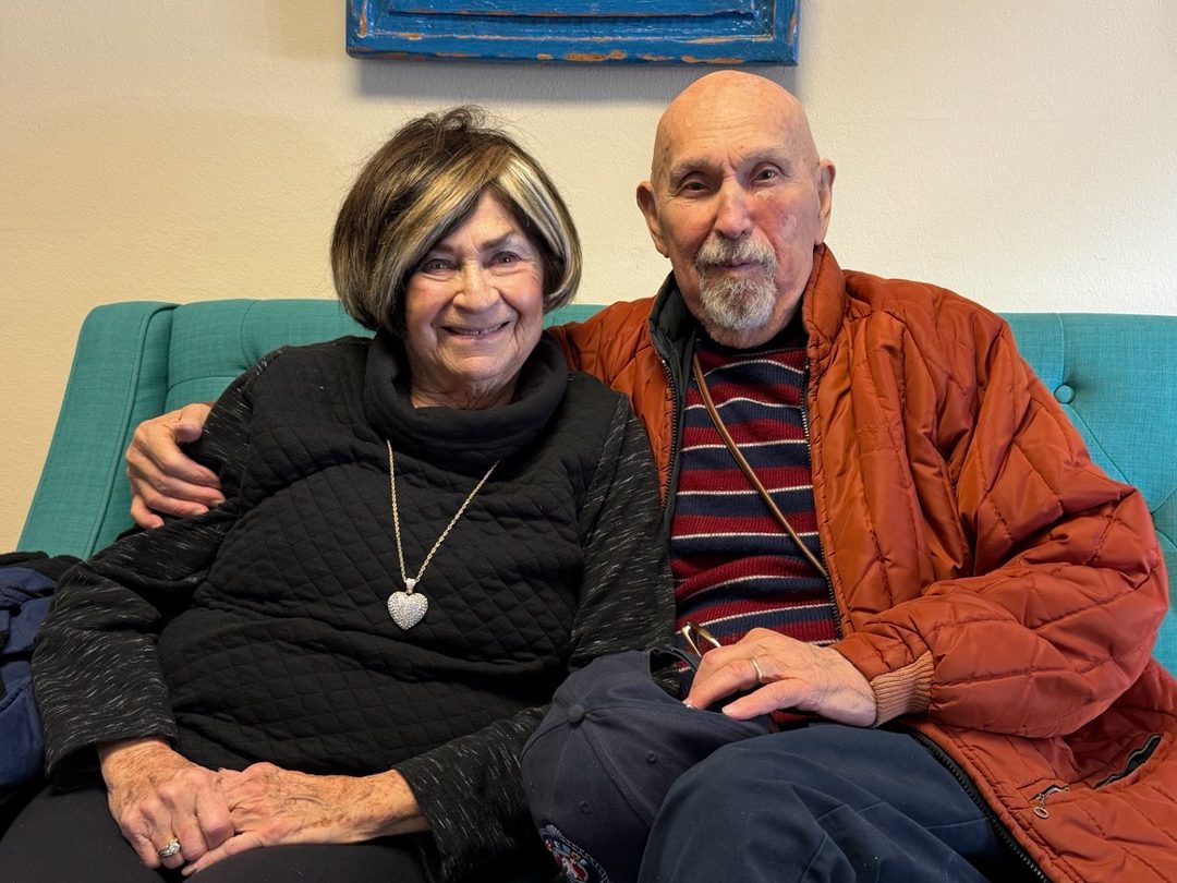 Helene and Bill posing for the camera on a couch