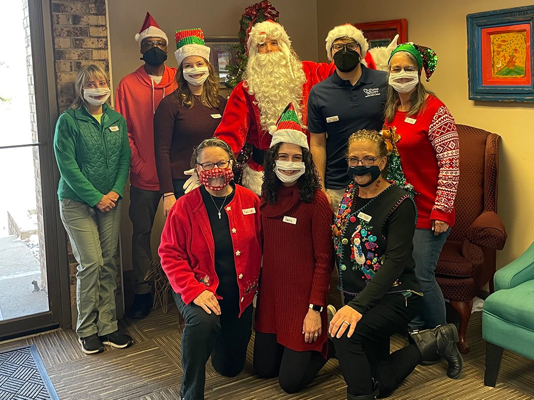 the MDC Staff posing with Santa Claus