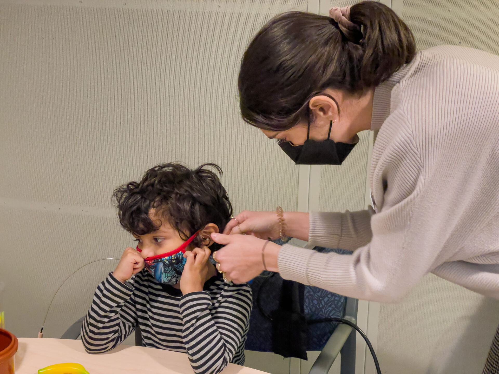 A kid and a doctor during an ear screening