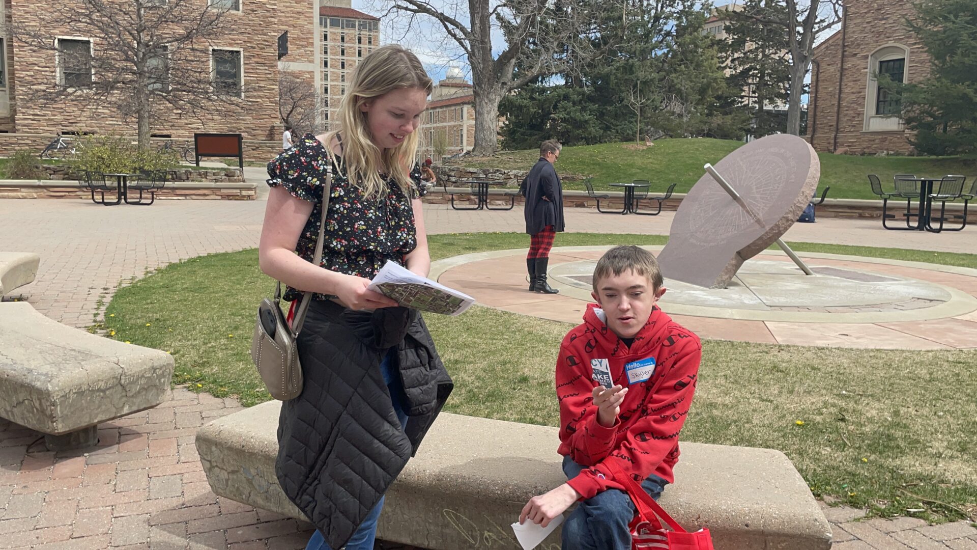 Woman showing instructions to a boy with autism