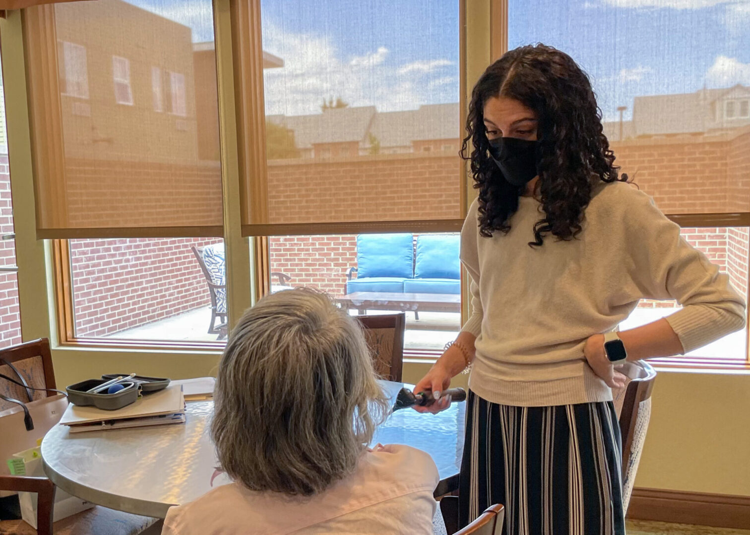 Dr. Emory Bratton speaks with a resident before performing an ear canal examination. 