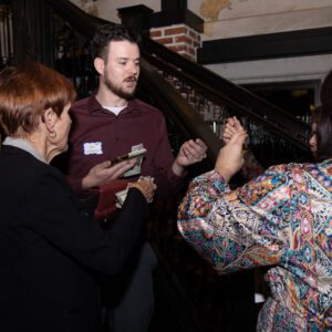 A group of people standing around each other.