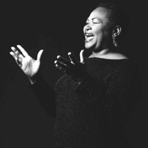 Woman passionately singing in black and white.
