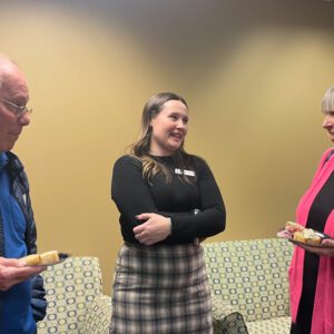 Three people conversing at a social gathering.