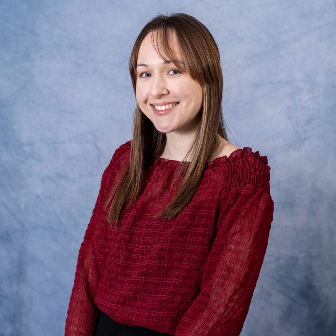 Smiling woman in a red blouse.
