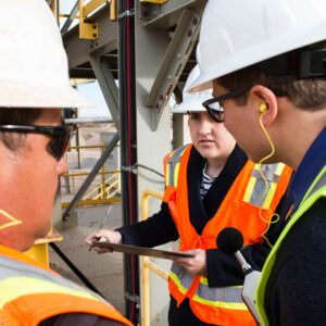 Construction workers discussing at a job site.